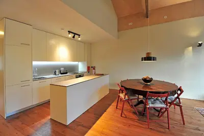 a kitchen and dining room with a table and chairs at FLH Oporto Captain House in Porto