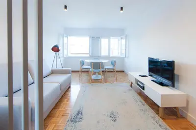 a living room with a couch and a tv at Citybreak-apartments Patio in Porto