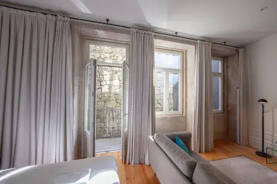 a living room with a couch and a window at Citybreak-apartments Patio in Porto