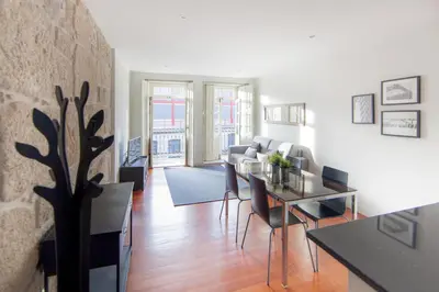 a living room with a dining room table and chairs at Citybreak-apartments Patio in Porto
