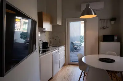 a kitchen with a table and a dining room at Alda's Vintage Apartments with Free Parking in Porto