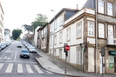 a street with cars parked on the side of a building at Alda's Vintage Apartments with Free Parking in Porto