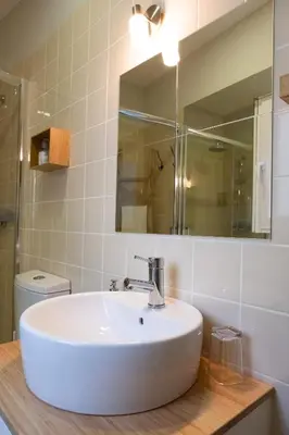 a bathroom with a white sink and a mirror at Alda's Vintage Apartments with Free Parking in Porto