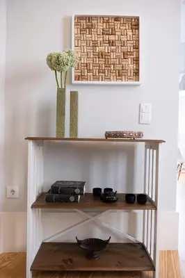 a shelf in a living room with a vase of flowers at Alda's Vintage Apartments with Free Parking in Porto