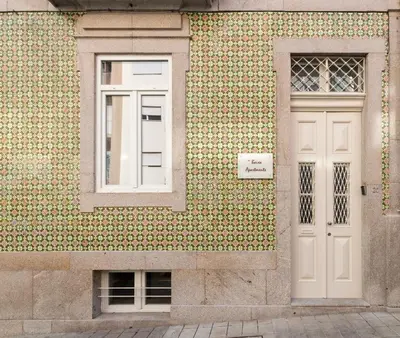 a building with a window and a white door at naBaixa Apartments in Porto