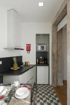 a kitchen with a table with plates on it at naBaixa Apartments in Porto