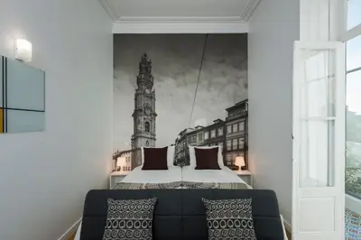 a bedroom with a bed and a large clock tower at naBaixa Apartments in Porto