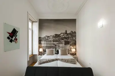 a bedroom with a wall mural of cities at naBaixa Apartments in Porto