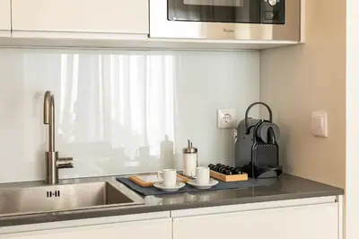 a kitchen counter with a sink and a microwave at Inn Oporto Downtown New Apartments in Porto