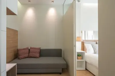 a living room with a couch and a bed at Inn Oporto Downtown New Apartments in Porto