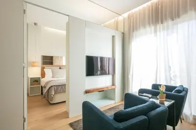 a living room with two blue chairs and a bed at Inn Oporto Downtown New Apartments in Porto