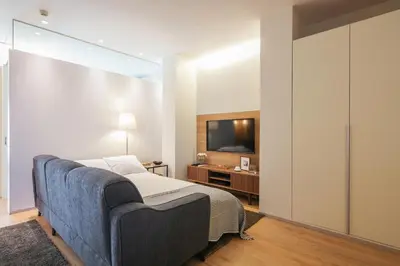 a bedroom with a bed and a flat screen tv at Inn Oporto Downtown New Apartments in Porto