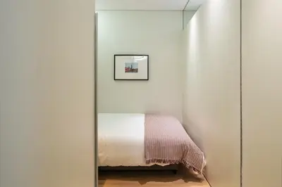 a bedroom with a mirror next to a bed at Oportments - Oliveiras in Porto