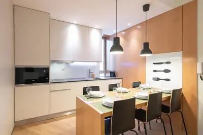 a kitchen with a dining room table and chairs at Oportments - Oliveiras in Porto