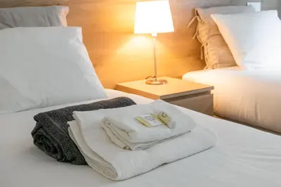 a hotel room with two towels on a bed at Oportments - Oliveiras in Porto