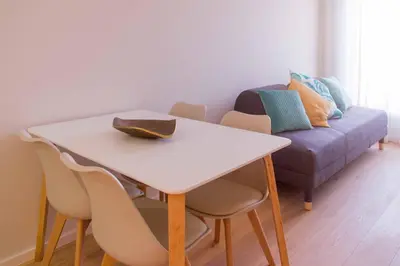 a table and chairs with a couch in a room at MH Duo in Porto