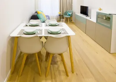 a dining room table with two chairs and a television at MH Duo in Porto