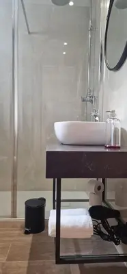 a bathroom with a sink and a shower at Alma Invicta Alegria in Porto