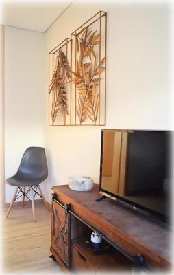 a living room with a television and a chair at Alma Invicta Alegria in Porto