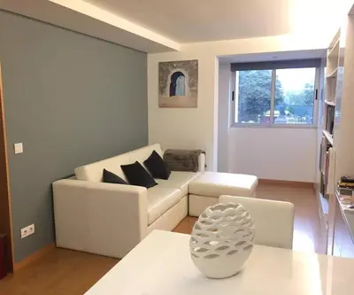 a living room with a white couch and a table at Maestro Appartment in Porto