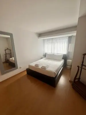 a bedroom with a bed and a large mirror at Maestro Appartment in Porto
