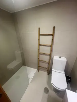a bathroom with a toilet and a towel rack at Maestro Appartment in Porto
