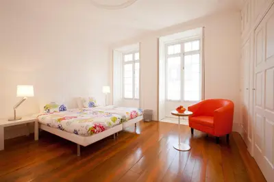 a room with two bunk beds and a table at Porto Lounge Hostel & Guesthouse by Host Wise in Porto