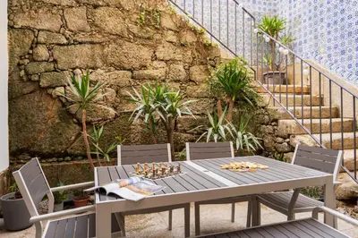 a courtyard with benches and a building at Porto Lounge Hostel & Guesthouse by Host Wise in Porto