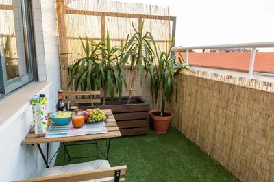 a table with fruit on a balcony with plants at Sunset Relaxing Apt with terrace, parking & bikes in Porto
