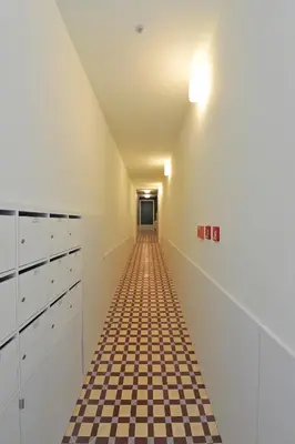 a hallway with a checkered floor and a ceiling at Oporto AAA - Almada Aliados Apartment in Porto