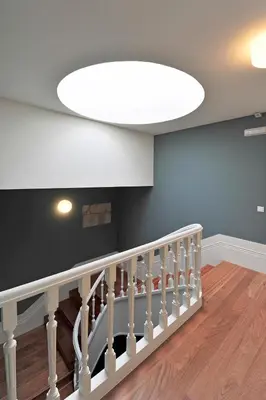 a white staircase with a large white ceiling at Oporto AAA - Almada Aliados Apartment in Porto