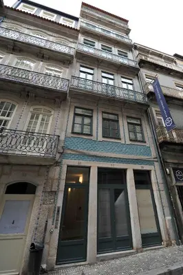 a building with windows and balconies on a street at Oporto AAA - Almada Aliados Apartment in Porto