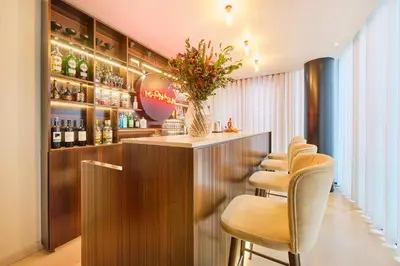 a bar with a row of stools in a room at Hotel Moon & Sun Porto in Porto