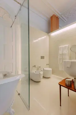 an apartment building with white chairs in front of it at Rosa Et Al Townhouse in Porto