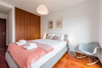 a bedroom with a bed and a chair in it at GuestReady - Jazz Apartment in Porto