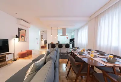 a living room with a long couch and a table at Bruno's Downtown Apartment in Porto