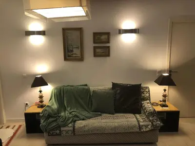 a living room with a couch and two lamps at BS VILLAS RC PORTO in Porto