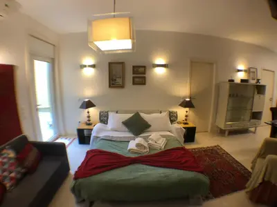 a bedroom with a bed with two towels on it at BS VILLAS RC PORTO in Porto