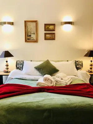 a bedroom with a bed with towels on it at BS VILLAS RC PORTO in Porto