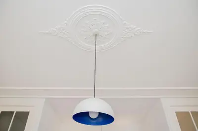 a ceiling light hanging from a white ceiling at Downtown Spacious Studio in Porto