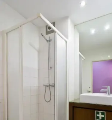 a bathroom with a shower and a sink at Porto Village Inn in Porto