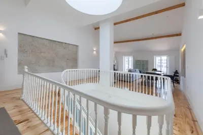 a white staircase in a room with a living room at Oporto City View - Wonderful Apartment in Porto