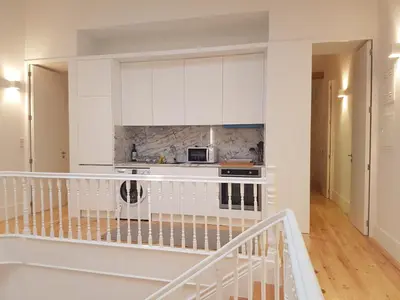 a kitchen with white cabinets and a stove at Oporto City View - Wonderful Apartment in Porto