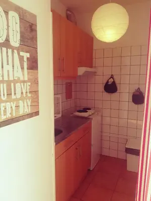 a small kitchen with red cabinets and white tiles at Oportobestview - TopLoft in Porto