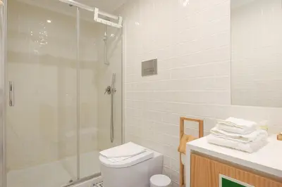 a bathroom with a shower and a toilet and a sink at Skylight Apartment in Porto