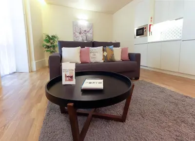 a living room with a couch and a coffee table at HM - Ribeira São João 1B in Porto