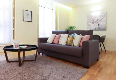 a living room with a couch and a table at HM - Ribeira São João 1B in Porto