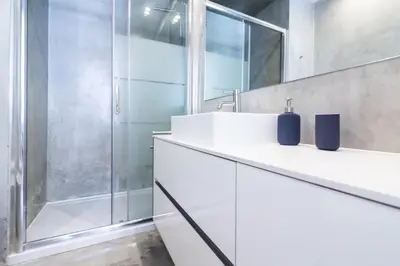 a bathroom with a white sink and a shower at ON Apartments - Violin in Porto