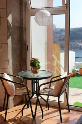 a small kitchen with wooden cabinets and a white refrigerator at Oportobestview-River in Porto