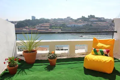 a living room with a table and a couch at Oportobestview-River in Porto